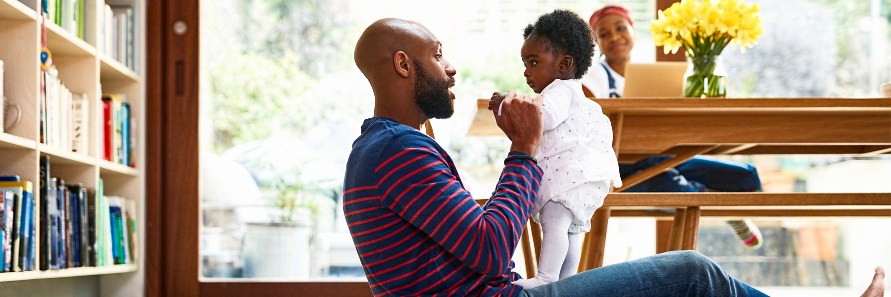 Photo of father playing with baby
